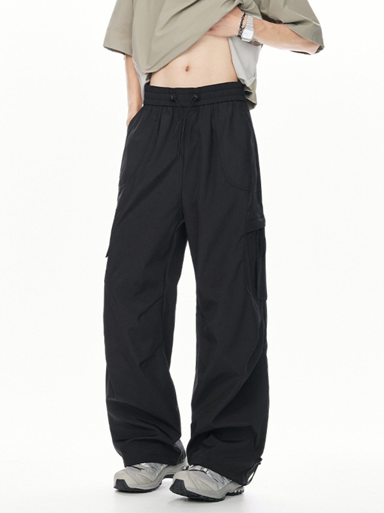 Men's black relaxed fit cargo sweatpants with adjustable drawstring waist and cinched ankles.