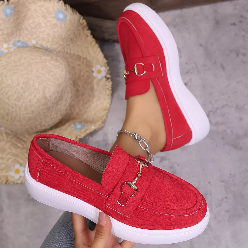 Red loafers with gold horse-bit detail and white sole, casual slip-on shoes for women.