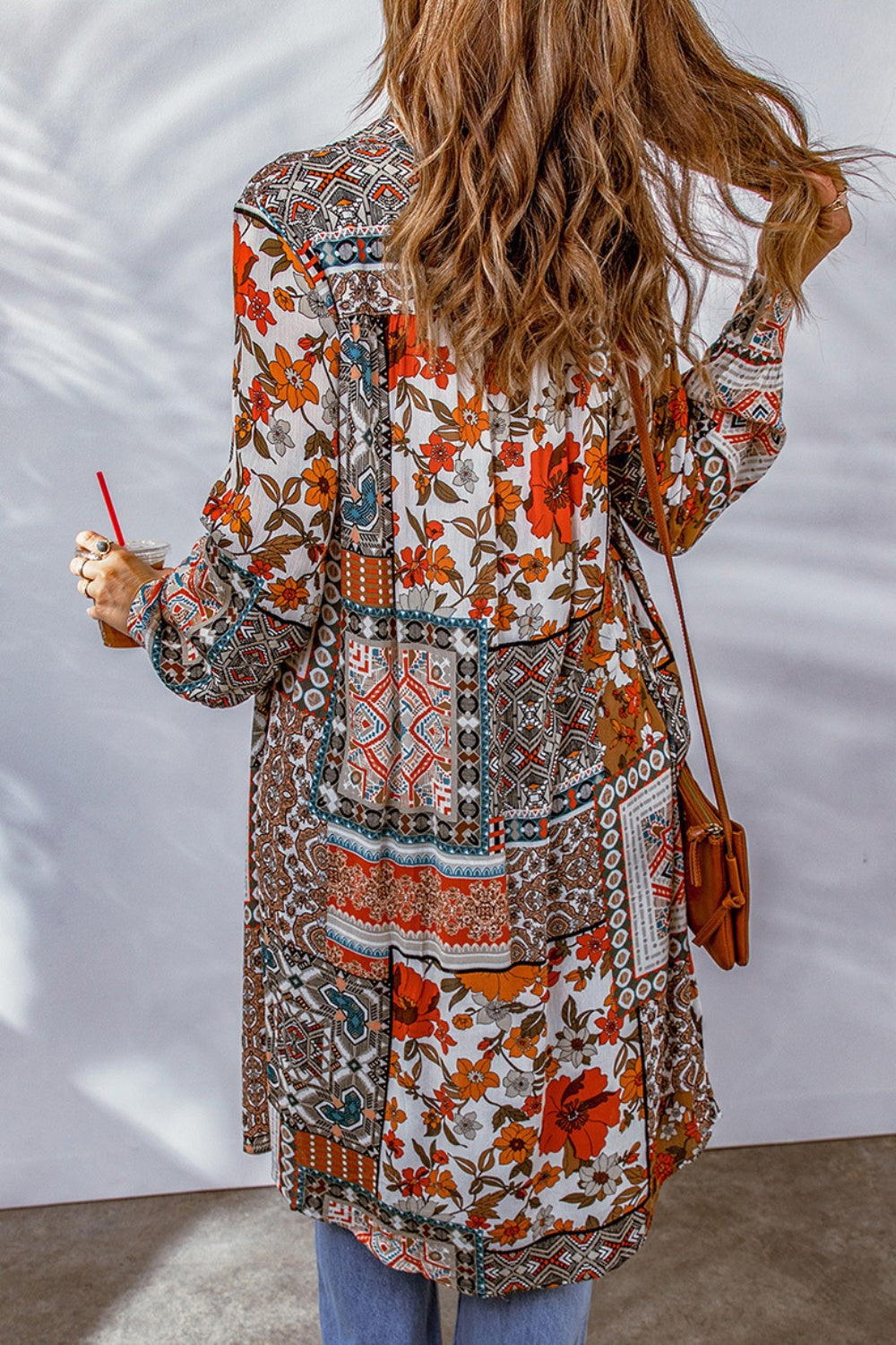 Patchwork print duster shirt jacket with button front and long sleeves.