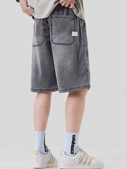 Dark gray loose fit denim shorts for men with elastic waist and back pockets.