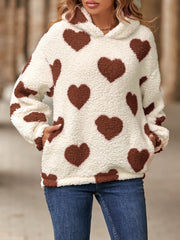 Cream sherpa hoodie with brown heart print and front pockets.