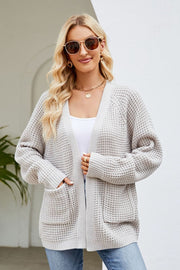 Light gray waffle knit cardigan with patch pockets and ribbed cuffs.