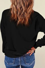 Black crewneck sweatshirt with glitter "Spooky" graphic detail.