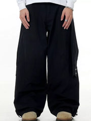 Black wide-legged cargo pants with buttoned pockets and drawstring cuffs.