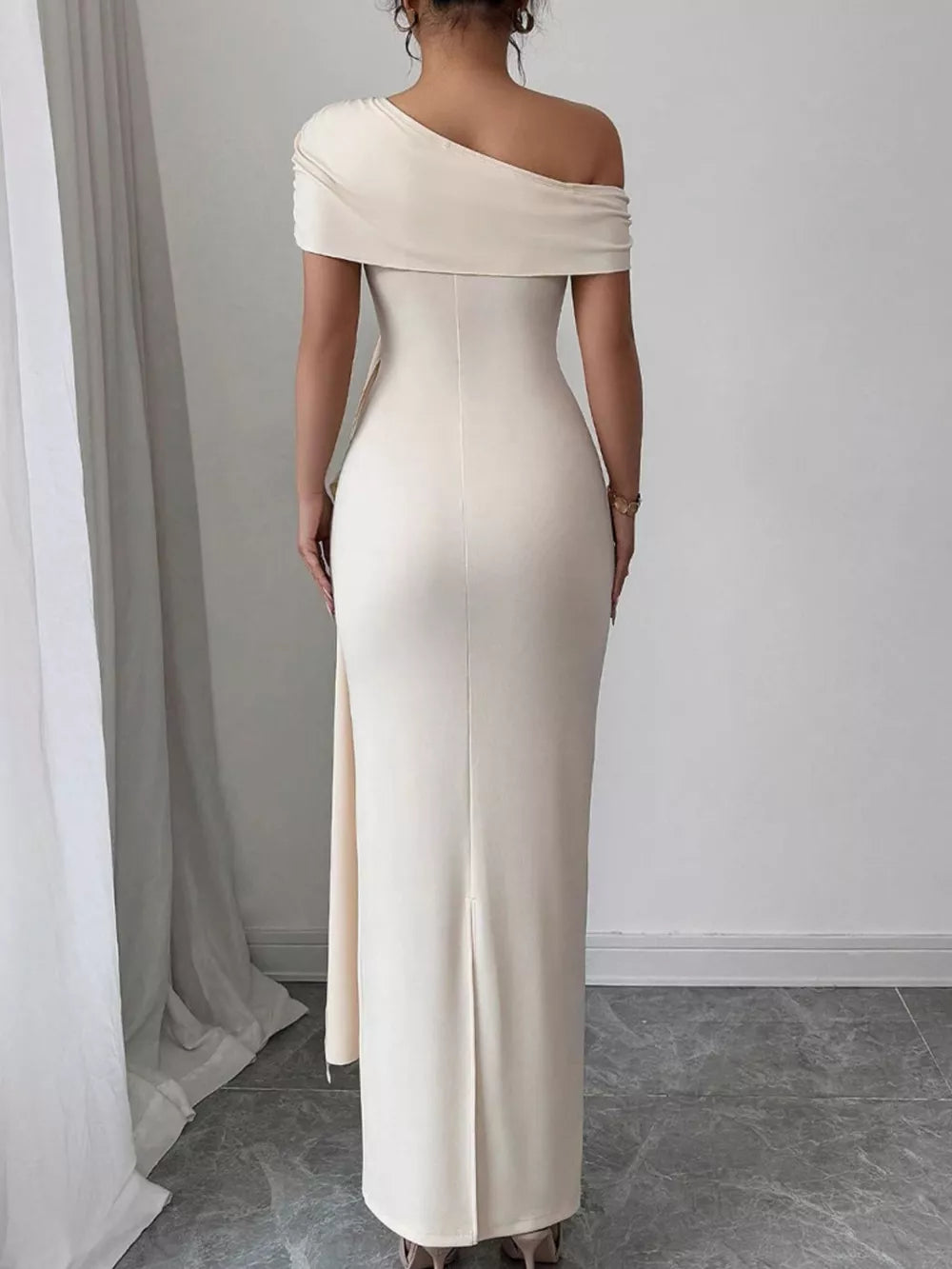 Apricot asymmetrical ruched maxi dress with off-the-shoulder neckline and side slit.