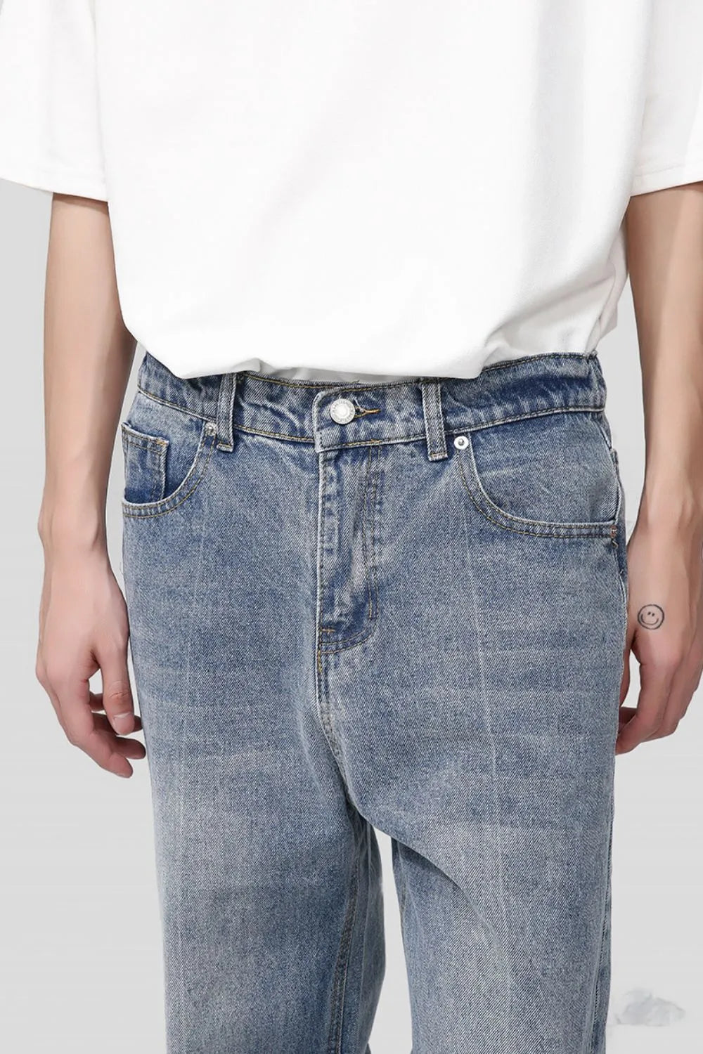 Pocketed denim jeans in medium wash with a relaxed fit.