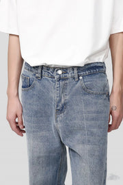Pocketed denim jeans in medium wash with a relaxed fit.