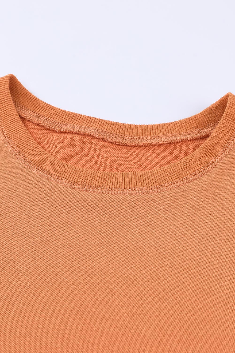 Orange crewneck sweatshirt with ribbed neckline and cuffs