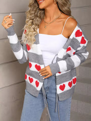 Grey and white striped acrylic cardigan with red heart pattern and tie front.