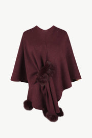 Wine knit cape with fur trim detail and pom poms.