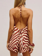 Backless halter neck two-piece set with zebra print in red and cream, featuring a tie back and flowy shorts.