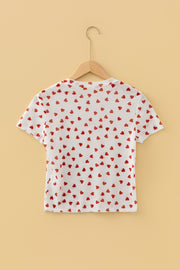 White sheer t-shirt with all-over red heart print, short sleeves, and a cropped fit.