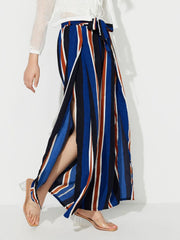 Striped palazzo trousers with side slits and a tie waist in blue, white, and rust stripes.