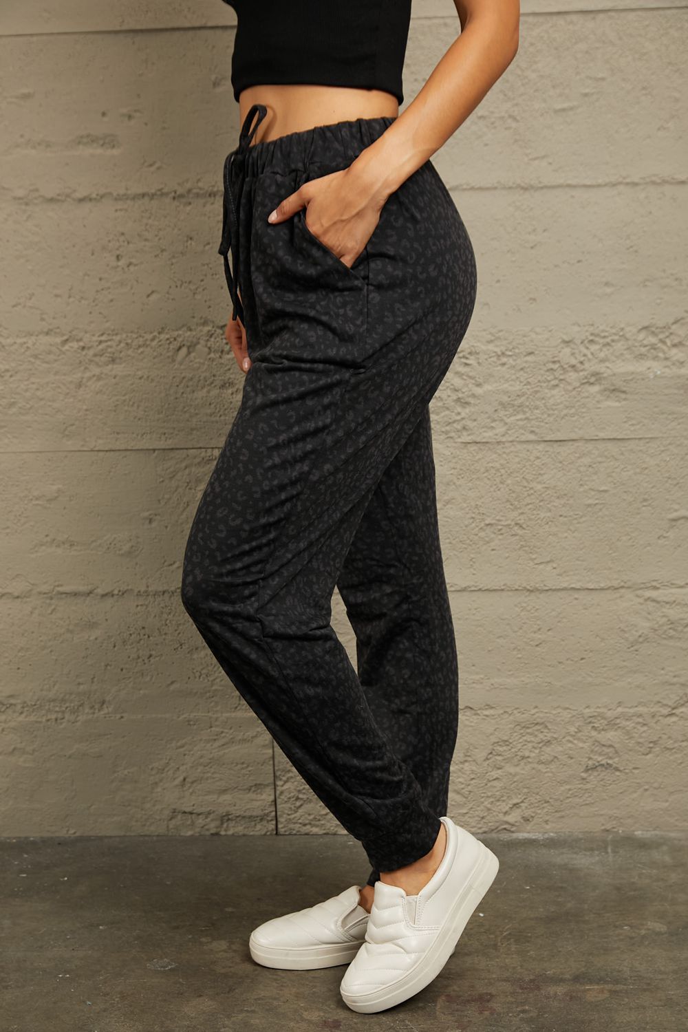 Black leopard print relaxed-fit drawstring trousers with pockets