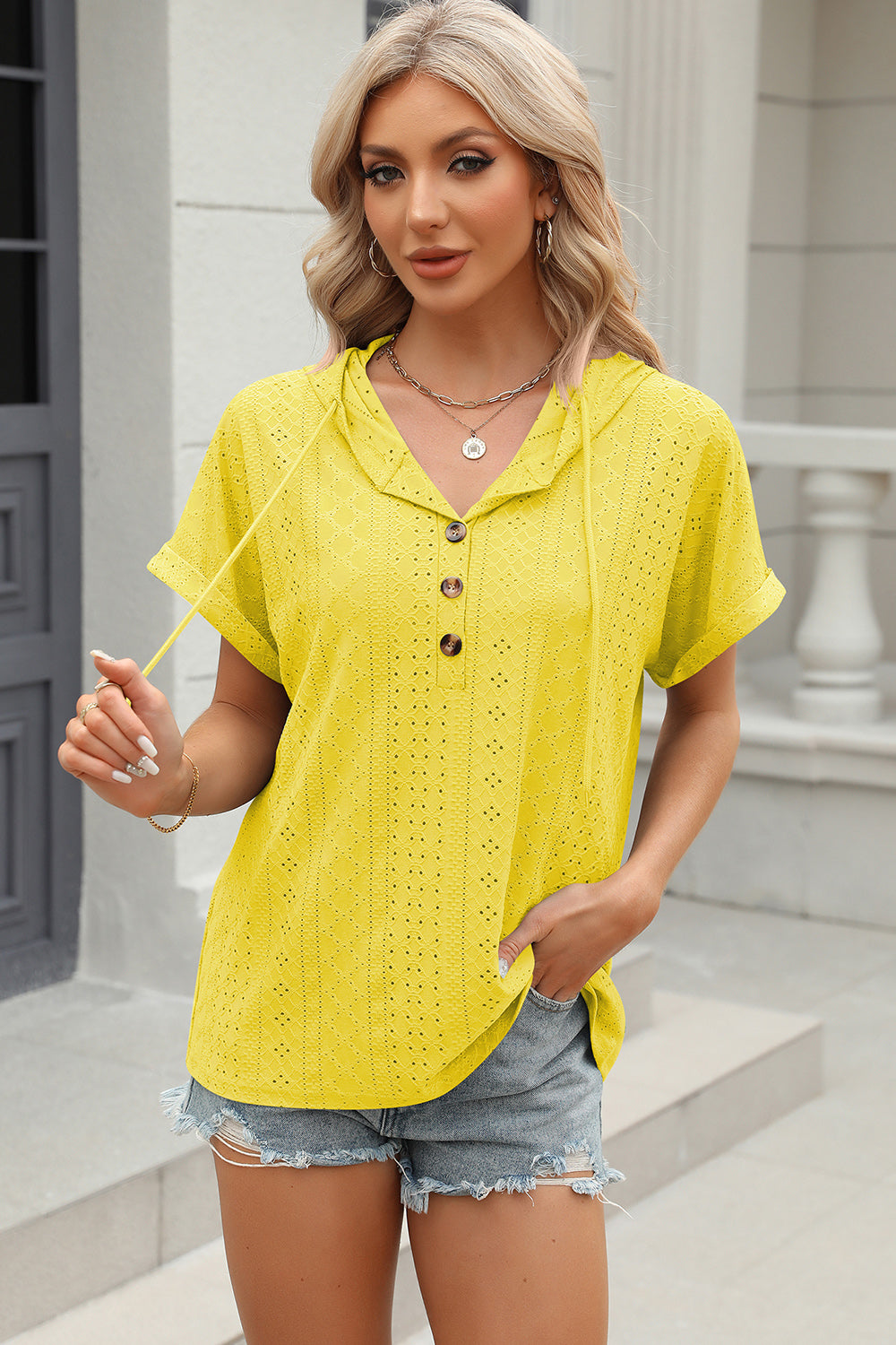 Yellow perforated henley hooded tee with button detail and short sleeves