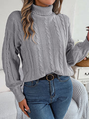 Dark Gray cable knit turtleneck sweater with voluminous sleeves and ribbed cuffs.