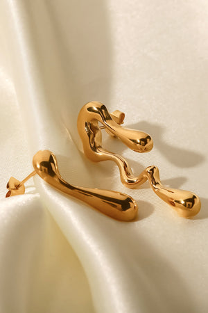 Gold asymmetrical drip earrings with artistic, fluid design.