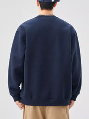 Navy blue oversized graphic sweatshirt with crewneck and ribbed cuffs.