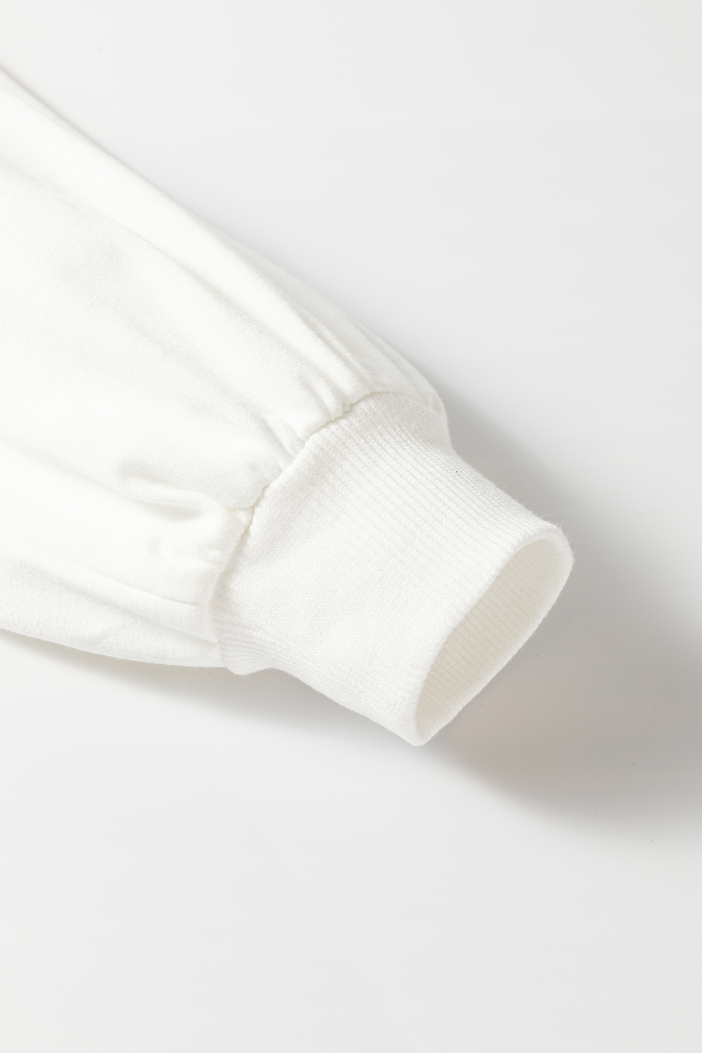 White raglan sleeve sweatshirt cuff detail