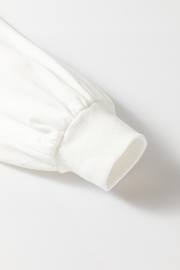 White raglan sleeve sweatshirt cuff detail