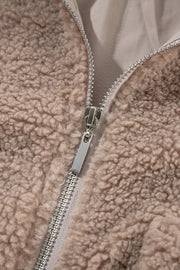 Mocha teddy bomber jacket with zip pockets and plush texture.