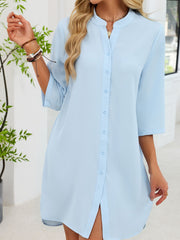 Light blue button-down shirt dress with band collar and 3/4 sleeves.