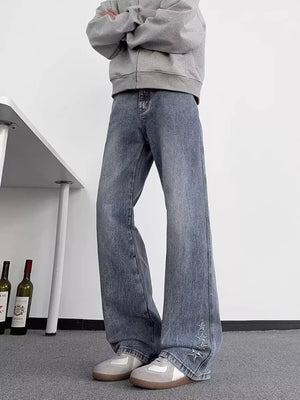 Men's blue wide-leg jeans with star embellishments on the hem.