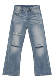 Distressed flare-leg jeans in medium wash denim with ripped details and a split hem.