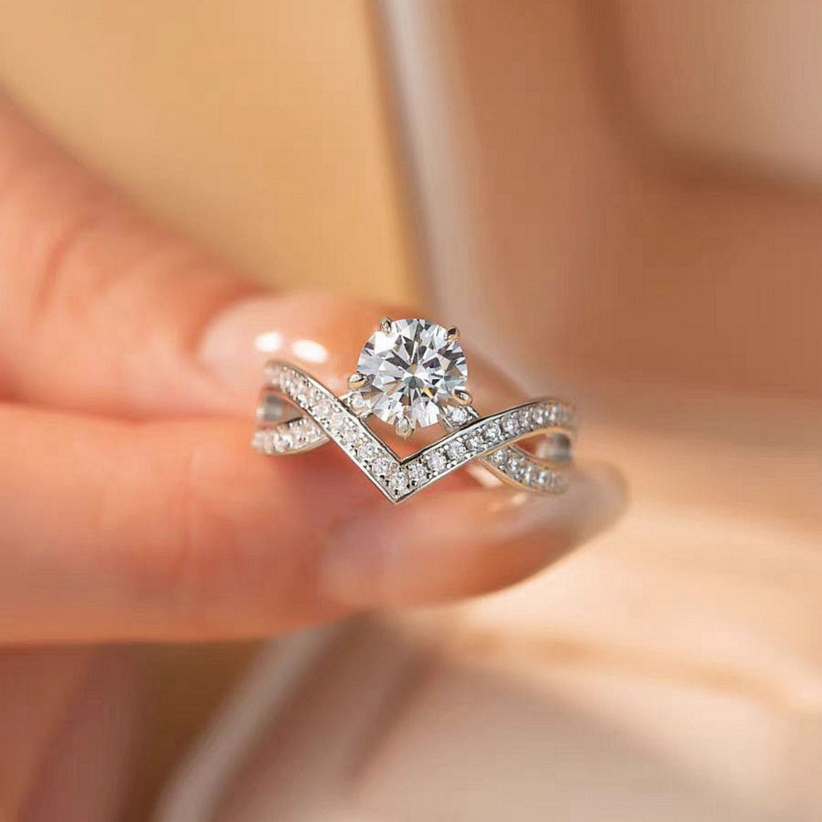 Moissanite sterling silver crossover ring with pave diamond band and solitaire center stone.