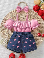Pink ruffled off-shoulder top and denim shorts with pink hearts, includes matching bow headband.