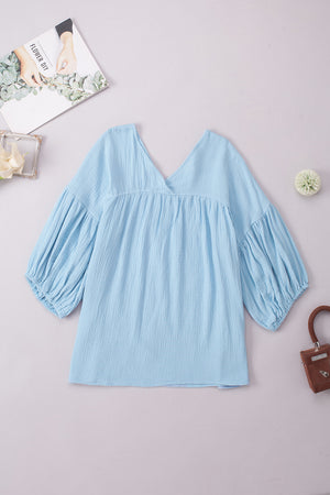 Pastel blue textured gauze blouse with gathered bishop sleeves and V-neck