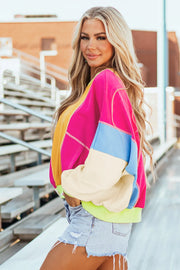 Colorblock sweatshirt with neon trim in pink, yellow, cream, and blue panels.