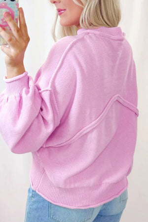 Pink knit sweater with puffed sleeves and contrast stitching detail