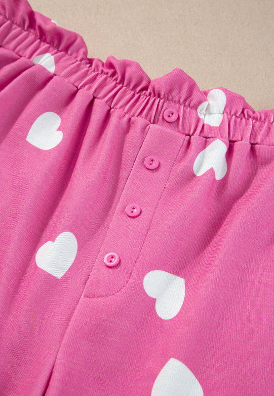 Hot pink heart print pajama shorts with elastic waist and button detail