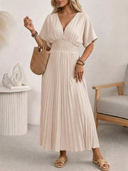 Apricot V-neck midi dress with smocked waist and pleated skirt.