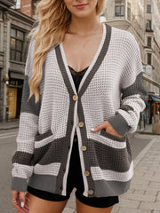 Waffle knit colorblock cardigan with V-neck, buttons, and pockets in gray and white.