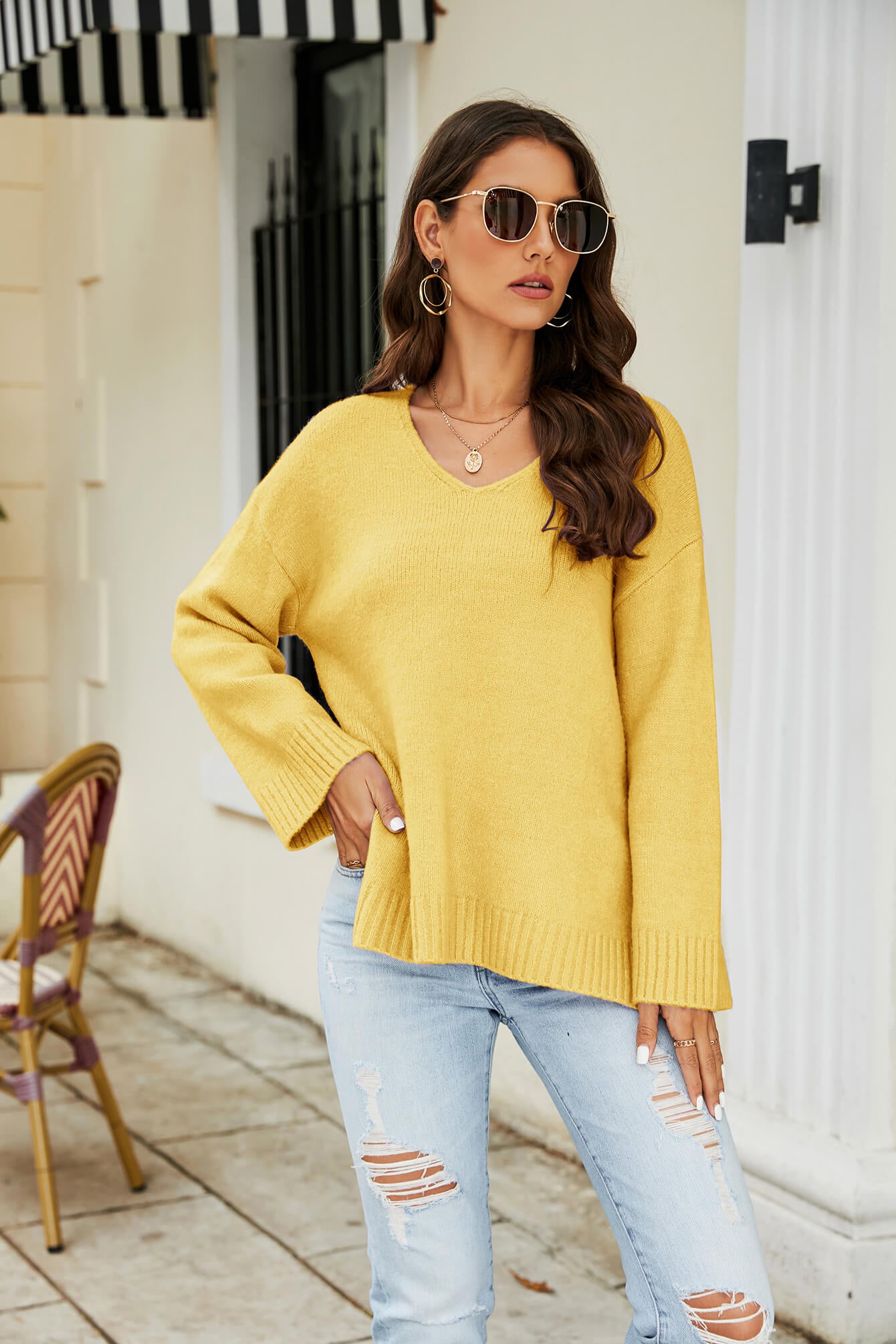 Yellow relaxed fit V-neck knit pullover sweater with long sleeves and ribbed trim.