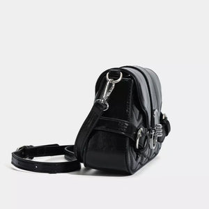 Black heart-quilted crossbody bag with buckle accents and a silver chain strap.