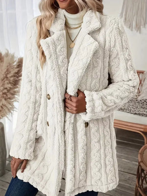 White faux shearling double-breasted coat with cable knit texture and button closure.
