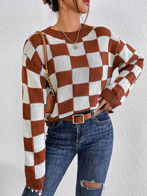 Checkerboard knit crewneck pullover sweater in chestnut and white acrylic with long sleeves.