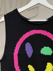 Black knit tank top with colorful smiley face graphic and round neckline.