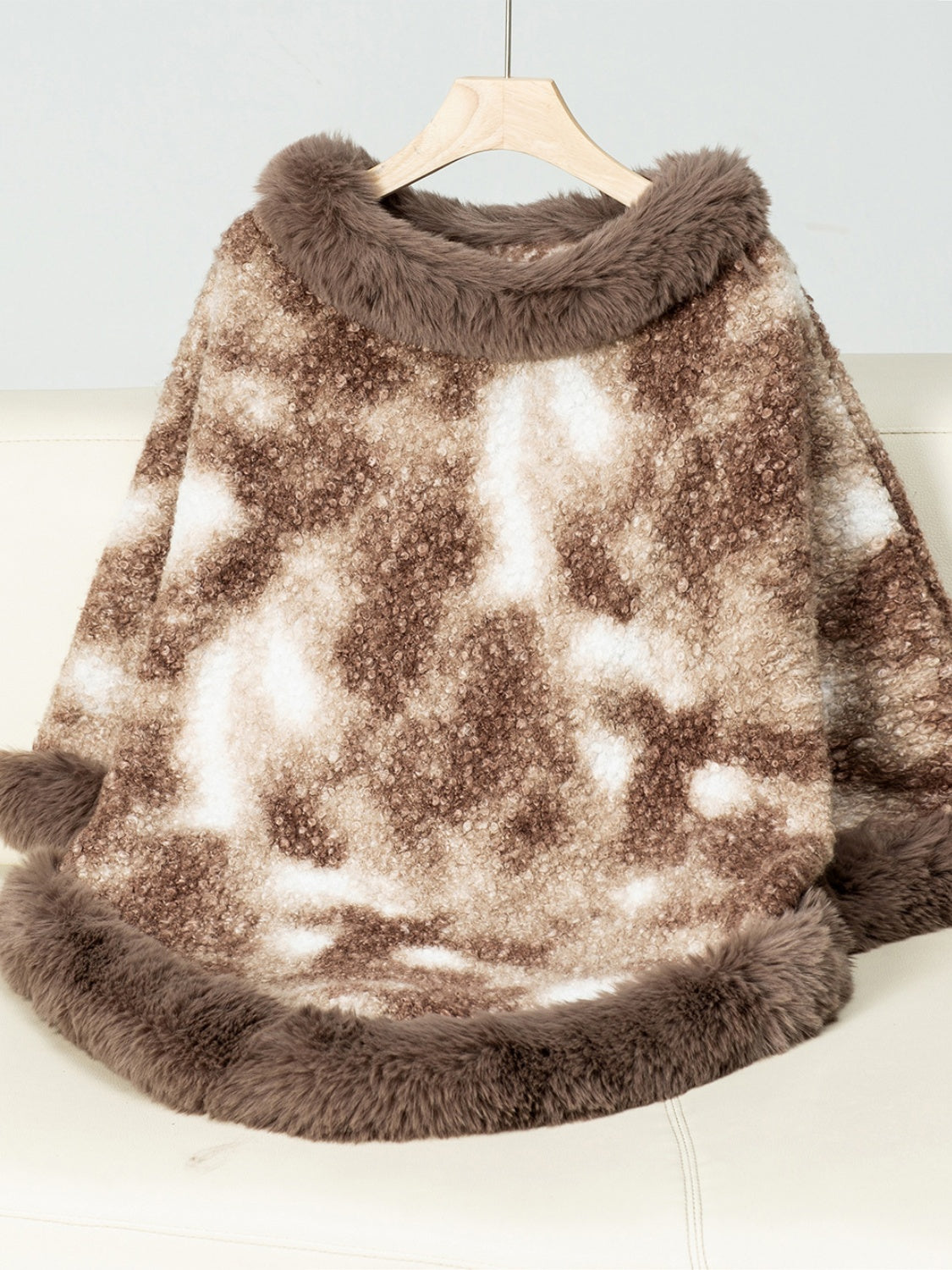 Faux fur trimmed camo poncho in Chocolate with a textured pattern and fuzzy trim.