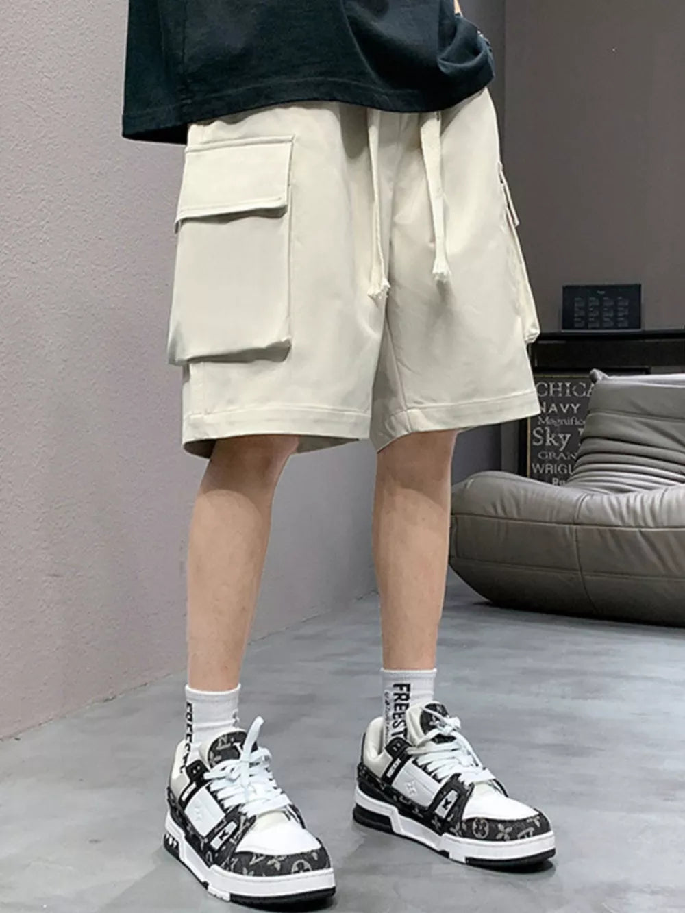 Apricot relaxed fit cargo shorts with drawstring and dual flap pockets.