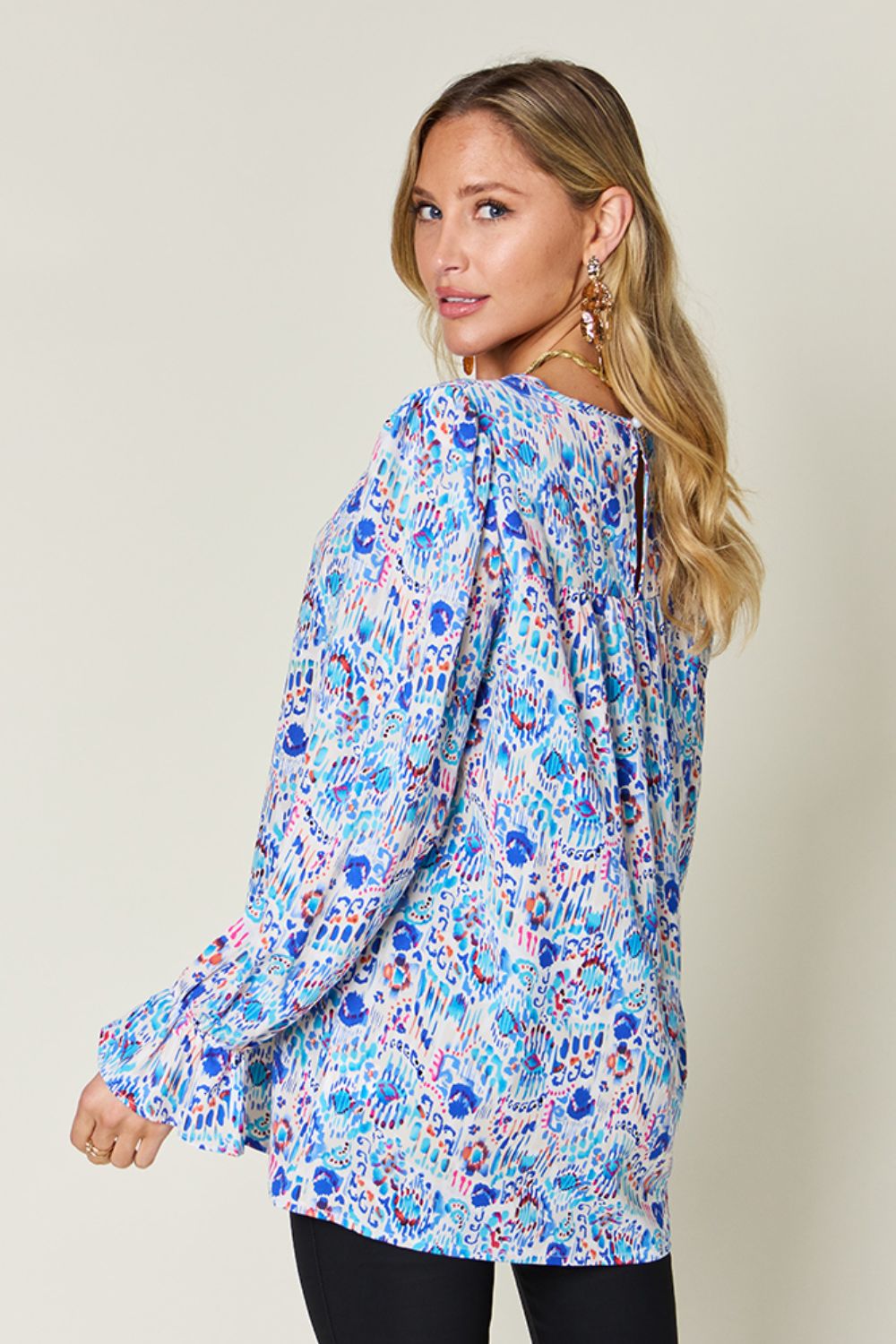 Painterly print blouse in sky blue with gathered sleeves and a keyhole back detail.