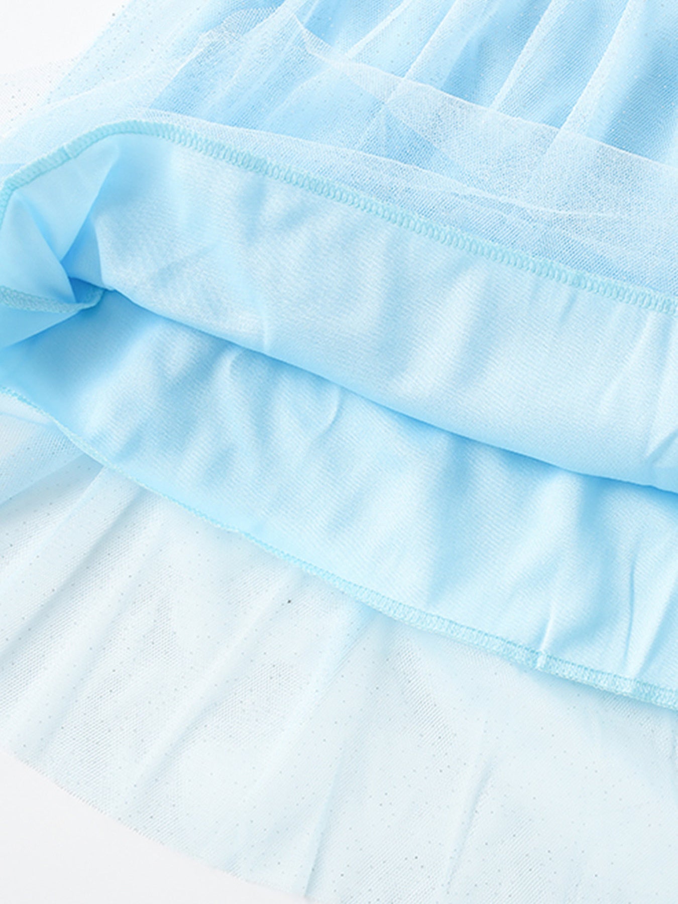 Blue toddler dress with layered tulle and cotton lining, featuring subtle sparkle details.