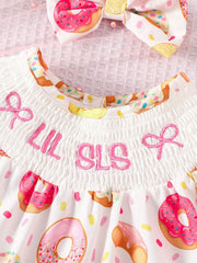 Baby smocked one-piece with donut print and LIL SLS embroidery.