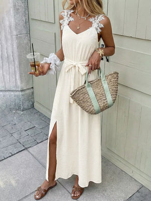Beige lace-trimmed V-neck maxi dress with tie waist and side slit.