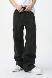 Dark wide-leg denim cargo pants with utility pockets and a relaxed fit.