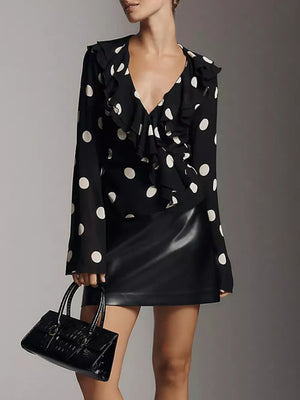 Black polka dot sheer v-neck blouse with ruffles and long sleeves.