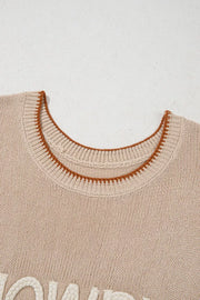 Beige knit sweater vest with contrast trim and textured lettering detail.